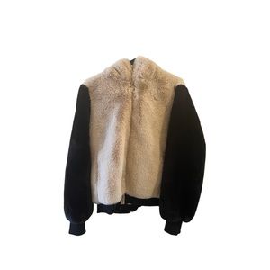 Fuzzy winter coat. Tan with black sleeves.